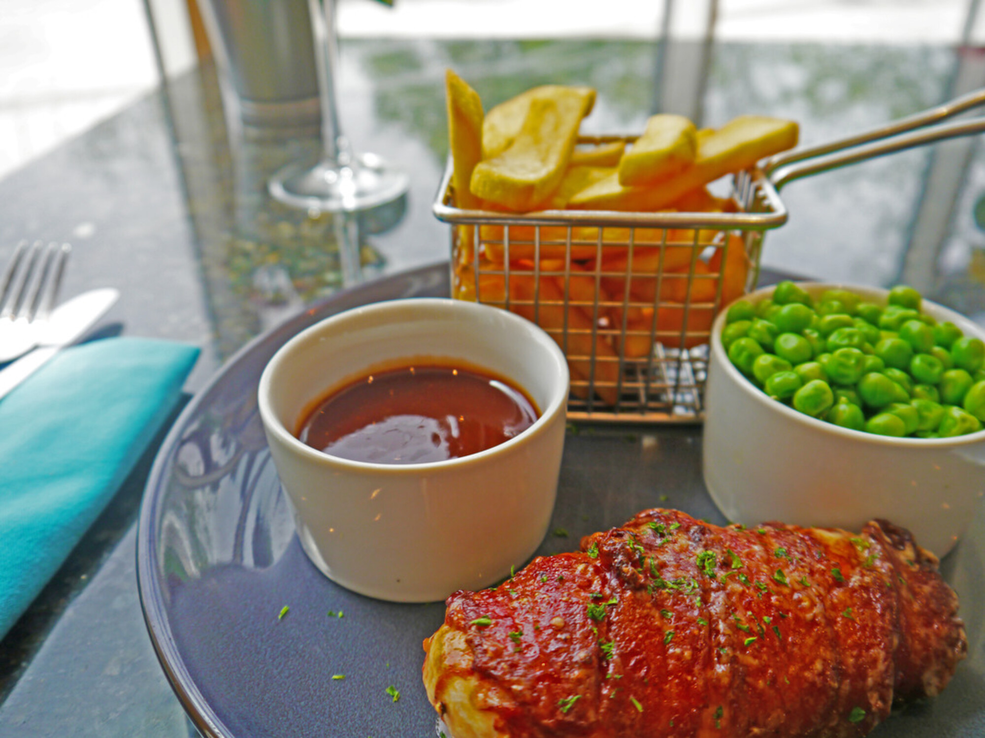 Lunch and Evening Menu: Hunter's chicken; chargrilled chicken breast stuffed with smoked cheddar cheese and wrapped in streaky bacon. Served with BBQ sauce, garden peas and chunky chips £13.50